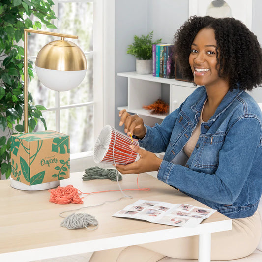 Cover your old plant pots with this knitting kit! Perfect for anyone who loves to knit or to give as a gift Kit comes with everything you need to knit your own planter! This crafters box contains a pot, three different colors of chunky yarn, needle, and templates
