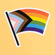 Load image into Gallery viewer, The Progress Pride Flag was created by graphic designer Daniel Quasar. Quasar’s design places a greater emphasis on inclusion and progression
