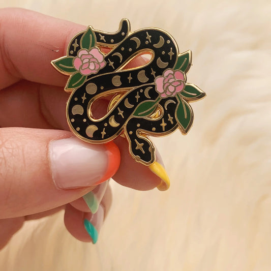 This magical snake enamel pin is intricately detailed with the moon phases & gorgeous pink flowers winding it's way through the serpent. 