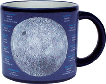 Load image into Gallery viewer, Here are two gorgeous Moon portraits-the &quot;magnificent desolation&quot; of the Near Side and the mysterious terrain of Far Side. When the mug is cold, you see the Moon(s) against a sea of black. Add a steaming beverage and watch the mug transform, revealing the names of Apollo missions, astronauts, landing sites, and milestones. 14 oz. ceramic mug. Comes in a colorful box. Color changing cups are microwave safe, but not dishwasher safe. Hand wash only. Don&#39;t soak.
