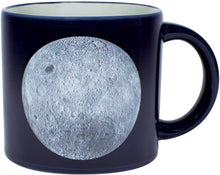 Load image into Gallery viewer, Here are two gorgeous Moon portraits-the &quot;magnificent desolation&quot; of the Near Side and the mysterious terrain of Far Side. When the mug is cold, you see the Moon(s) against a sea of black. Add a steaming beverage and watch the mug transform, revealing the names of Apollo missions, astronauts, landing sites, and milestones. 14 oz. ceramic mug. Comes in a colorful box. Color changing cups are microwave safe, but not dishwasher safe. Hand wash only. Don&#39;t soak.
