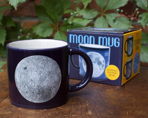 Here are two gorgeous Moon portraits-the "magnificent desolation" of the Near Side and the mysterious terrain of Far Side. When the mug is cold, you see the Moon(s) against a sea of black. Add a steaming beverage and watch the mug transform, revealing the names of Apollo missions, astronauts, landing sites, and milestones. 14 oz. ceramic mug. Comes in a colorful box. Color changing cups are microwave safe, but not dishwasher safe. Hand wash only. Don't soak.