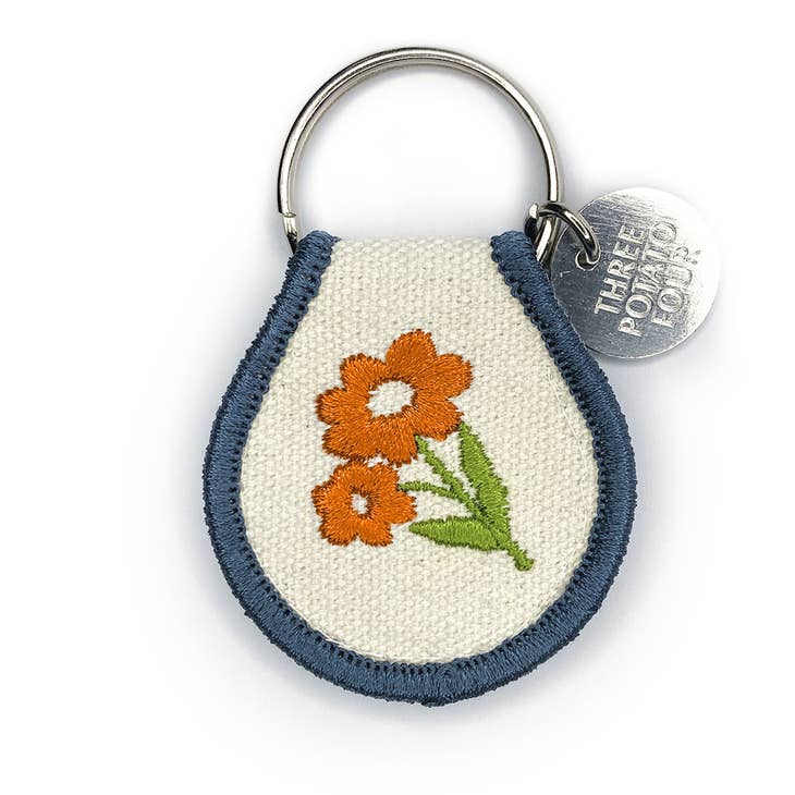 Show your keys some love with one of our patch keychains. Super cute and eye-catching, our double-sided embroidered keychain designs range from flowers and strawberries to sheep and chickens - which makes me think we pretty much got it all covered. Made with high-quality materials for a durable, long-lasting accessory. "Orange Blossom" Retro Inspired Great gift Your new favorite accessory Embroidered Natural Cotton Patch Keychain Double-Sided Embroidery Metal Split Keyring. 2.5" x 1.5"