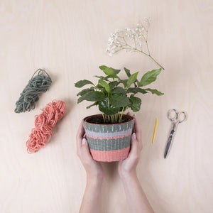 Cover your old plant pots with this knitting kit!  Perfect for anyone who loves to knit or to give as a gift  Kit comes with everything you need to knit your own planter!  This crafters box contains a pot, three different colors of chunky yarn, needle, and templates 