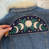 Blame it on the moon...moon phases XL back patch that is! Designed to perfectly adorn the back of jackets. Intricately embroidered with the moon phases & botanical leaves against a magical night sky. Wildflower + Co. DIY.