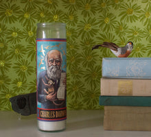 Load image into Gallery viewer, Show your devotion to Charles Darwin, the patron saint of slow, random, gradual, adaptive change (and finches), with this colorful votive! This candle will look great in your study, in your state room, or in the hot-house as you make notes on the orchids and carnivorous plants.
