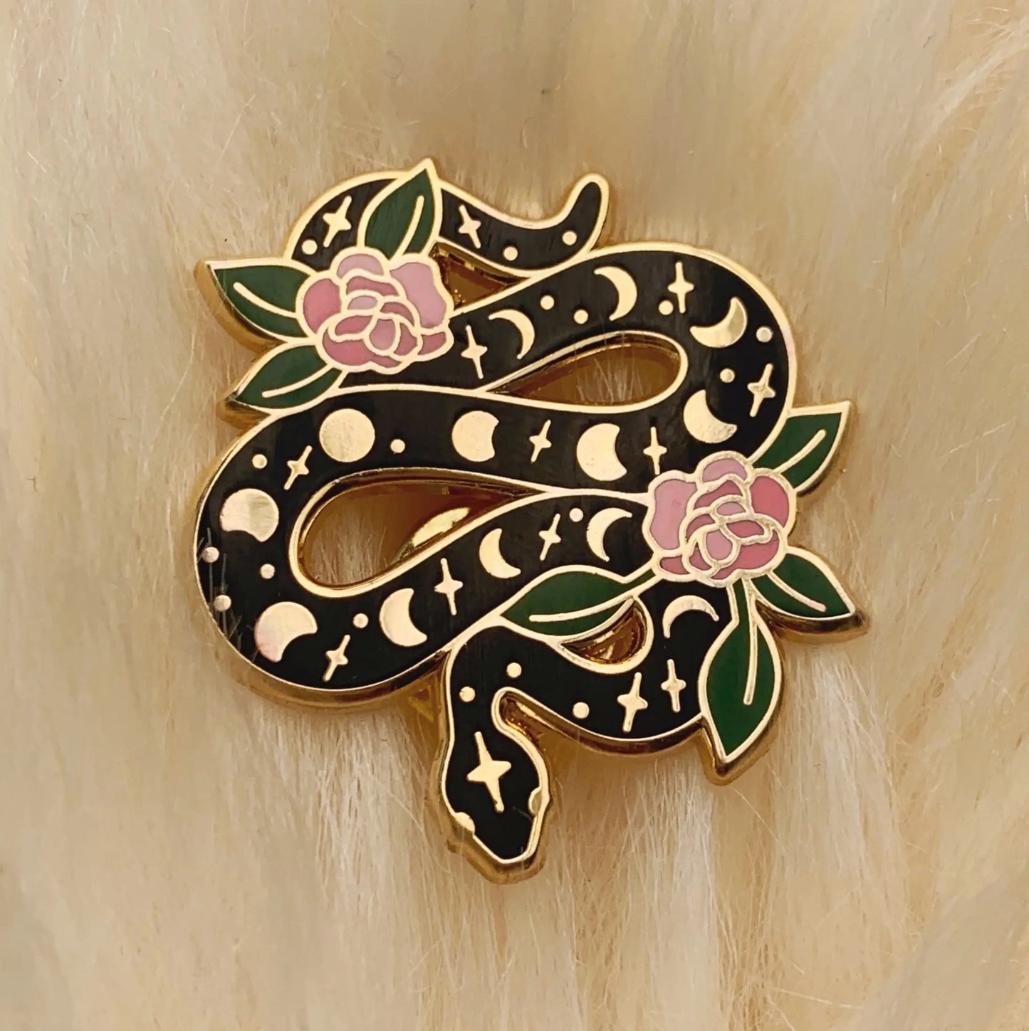 This magical snake enamel pin is intricately detailed with the moon phases & gorgeous pink flowers winding it's way through the serpent. 