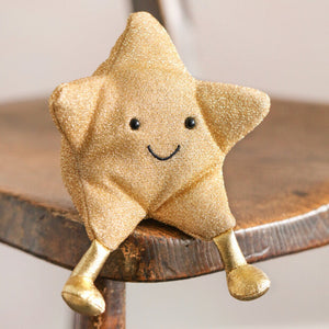 With a smiley face and cuddly body, this fun little plush guy will sparkle among presents beneath your Christmas tree or tucked up in bed on Christmas Eve. His gorgeous gold-foil body would make a great textural toy for a little one in your life!
